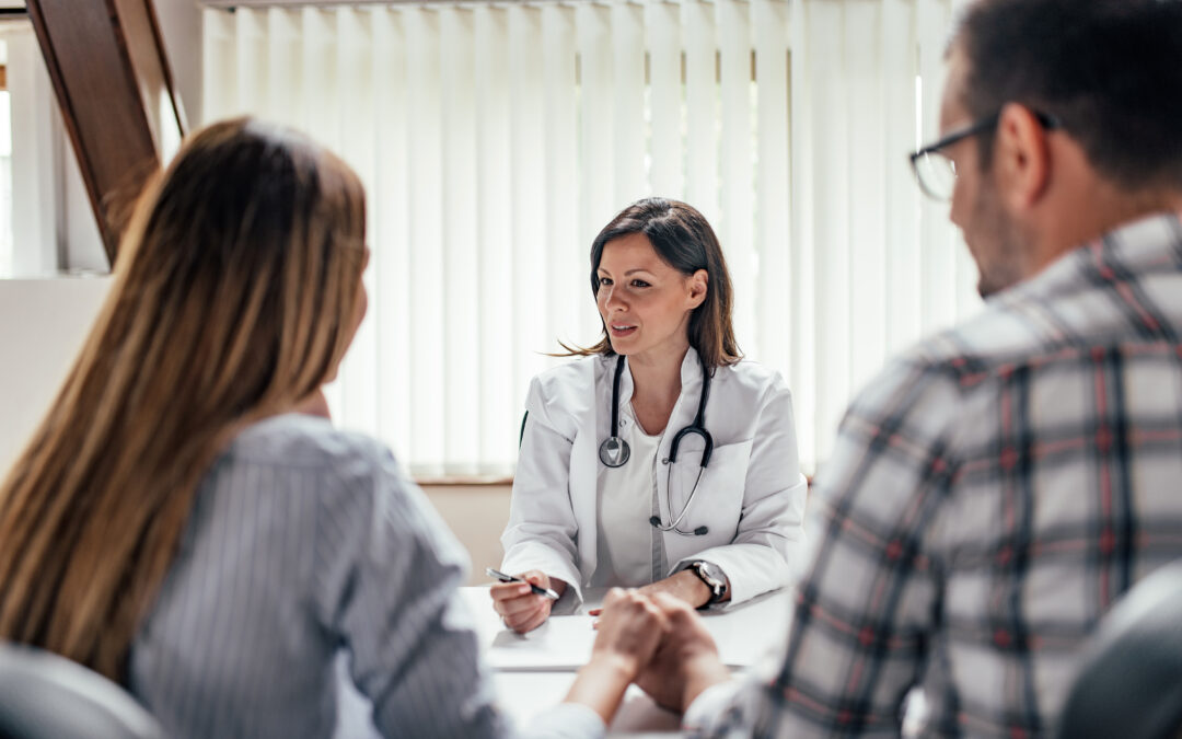 Doctor talking to a couple.