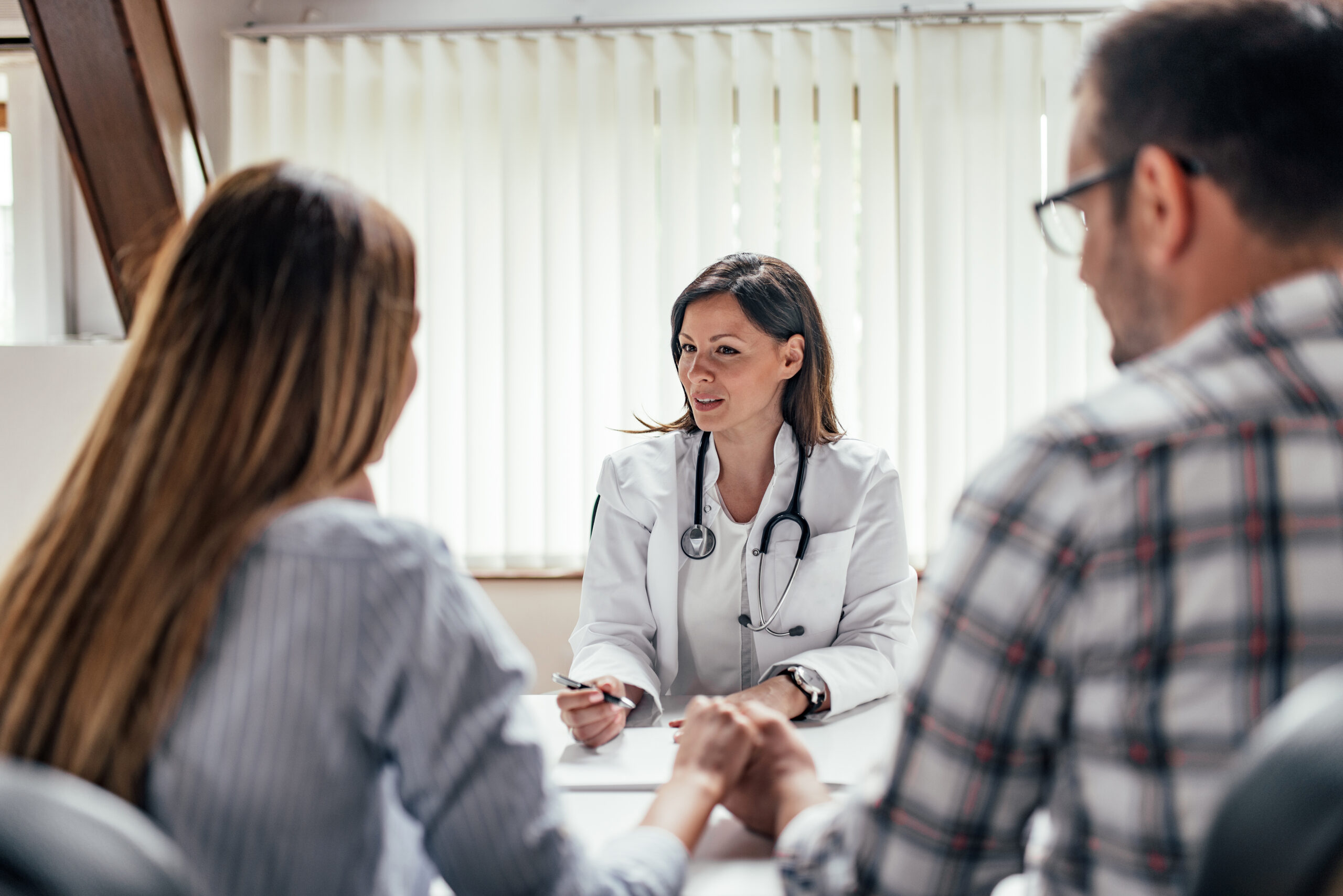Doctor talking to a couple.